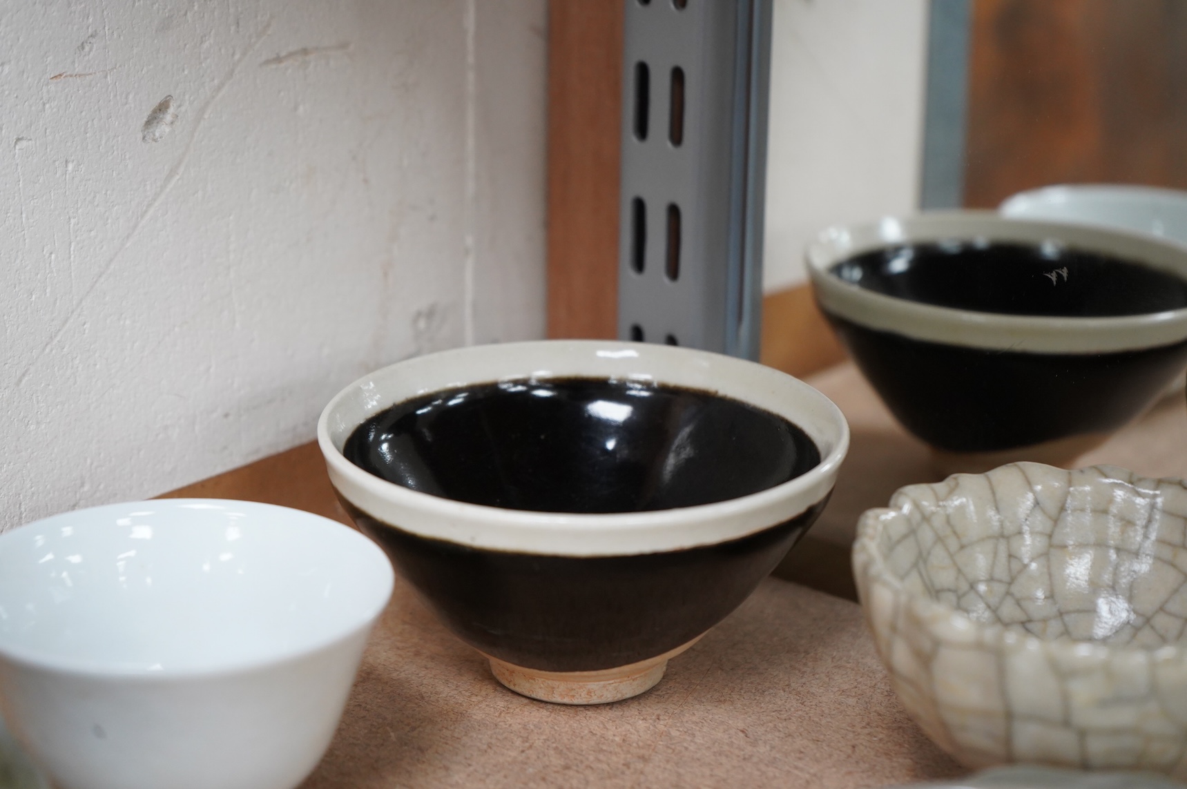A collection of Chinese porcelain and pottery to include a naturalistic teapot, crackle glaze bowl and a ‘dragon’ bowl, largest 10cm in diameter